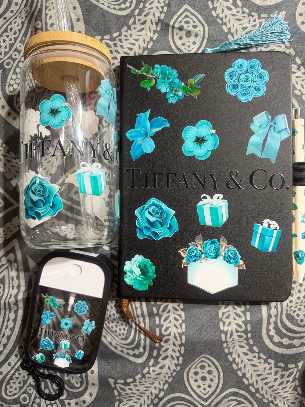 Black & teal journal with matching pen, bookmark, spray bottle & glass tumbler.